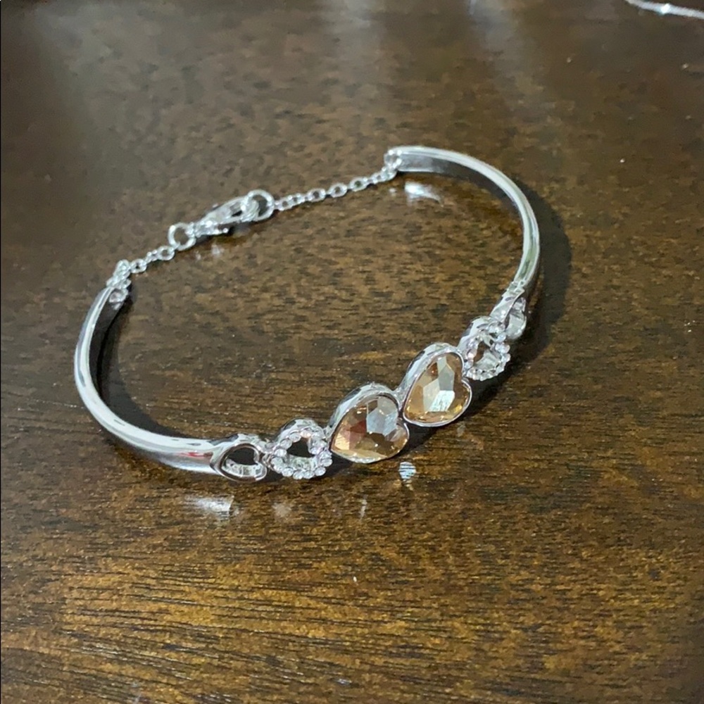 Sterling silver bangle with gold hearts.